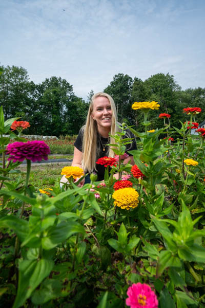 My friend Emma Graham smiling in a field of Zinnias at Peterson Farms.