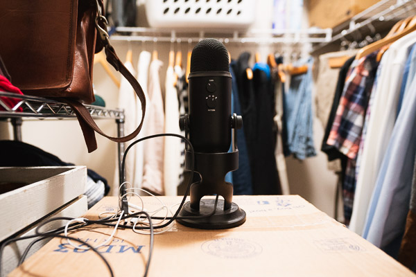 My Blue Yeti in my recording studio (the closet) teetering on leftover Christmas boxes and cat litter containers.